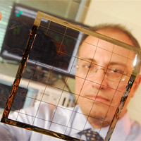 <p>
	Georgia Tech School of Electrical and Computer Engineering professor Manos Tentzeris displays an inkjet-printed rectifying antenna used to convert microwave energy to DC power. This grid was printed on flexible Kapton material and is expected to operate with frequencies as high as 10 gigahertz when complete.</p>
<p>
	Credit: Gary Meek</p>
