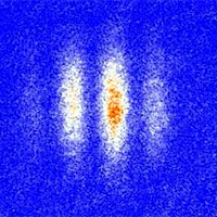 Atoms interfering with themselves. After ultracold atoms are maneuvered into superpositions—each one located in two places simultaneously—they are released to allow interference of each atom’s two “selves.” They are then illuminated with light, which casts a shadow, revealing a characteristic interference pattern, with red representing higher atom density. The variations in density are caused by the alternating constructive and destructive interference between the two “parts” of each atom, magnified by thousands of atoms acting in unison.<br /><br />Credit: NIST