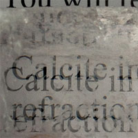 <p>
	This image shows a calcite crystal laid upon a paper, causing all the letters to show double refraction.</p>
