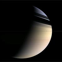 Shadows of rings fall on Saturn. The moon Enceladus is visible right of center in the ringplane. <br/>
<br/>
Image credit: NASA/JPL/Space Science Institute