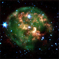 This false-color image from NASA's Spitzer Space Telescope shows a dying star (center) surrounded by a cloud of glowing gas and dust. Thanks to Spitzer's dust-piercing infrared eyes, the new image also highlights a never-before-seen feature -- a giant ring of material (red) slightly offset from the cloud's core. This clumpy ring consists of material that was expelled from the aging star. 
<P>
The star and its cloud halo constitute a 'planetary nebula' called NGC 246. When a star like our own Sun begins to run out of fuel, its core shrinks and heats up, boiling off the star's outer layers. Leftover material shoots outward, expanding in shells around the star. This ejected material is then bombarded with ultraviolet light from the central star's fiery surface, producing huge, glowing clouds -- planetary nebulas -- that look like giant jellyfish in space. 
<P>
In this image, the expelled gases appear green, and the ring of expelled material appears red. Astronomers believe the ring is likely made of hydrogen molecules that were ejected from the star in the form of atoms, then cooled to make hydrogen pairs. The new data will help explain how planetary nebulas take shape, and how they nourish future generations of stars. 
<P>
This image composite was taken on Dec. 6, 2003, by Spitzer's infrared array camera, and is composed of images obtained at four wavelengths: 3.6 microns (blue), 4.5 microns (green), 5.8 microns (orange) and 8 microns (red). 
<P>
Image Credit: 
NASA/JPL-Caltech/CfA 