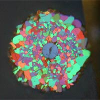 The image is a cross section of a 5 percent carbon-doped wire taken with polarized light. The picture shows all of the small, ~10-micron-sized grains lit up in wonderful colors. (Photo courtesy of the U.S. Dept. of Energy's Ames Laboratory)

